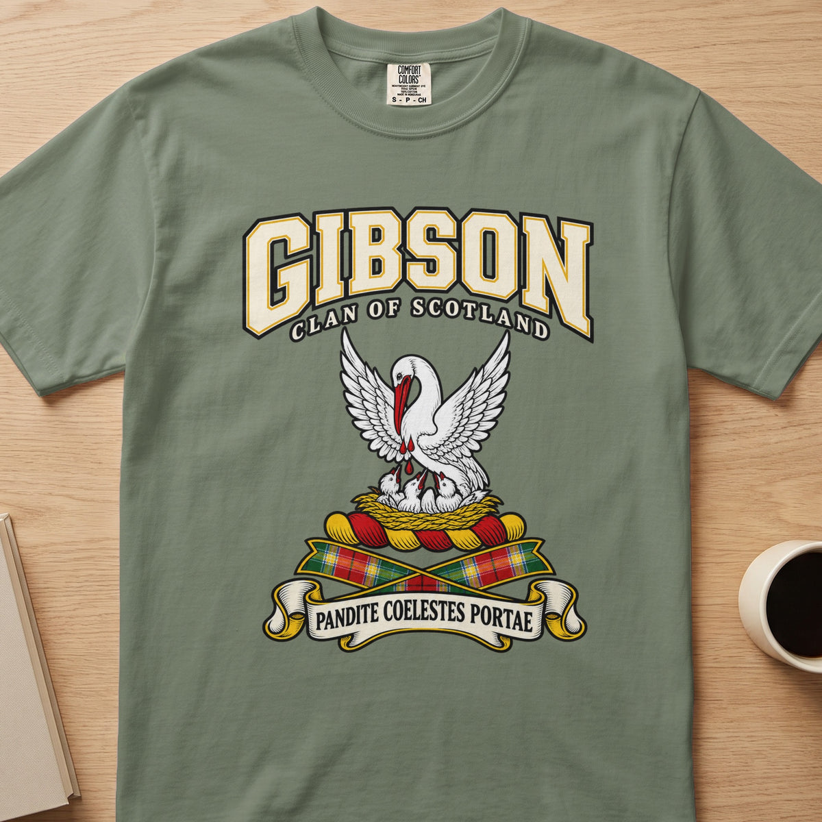Gibson white bird with lifted wings graphic on a sage green Comfort Colors T-shirt, front view