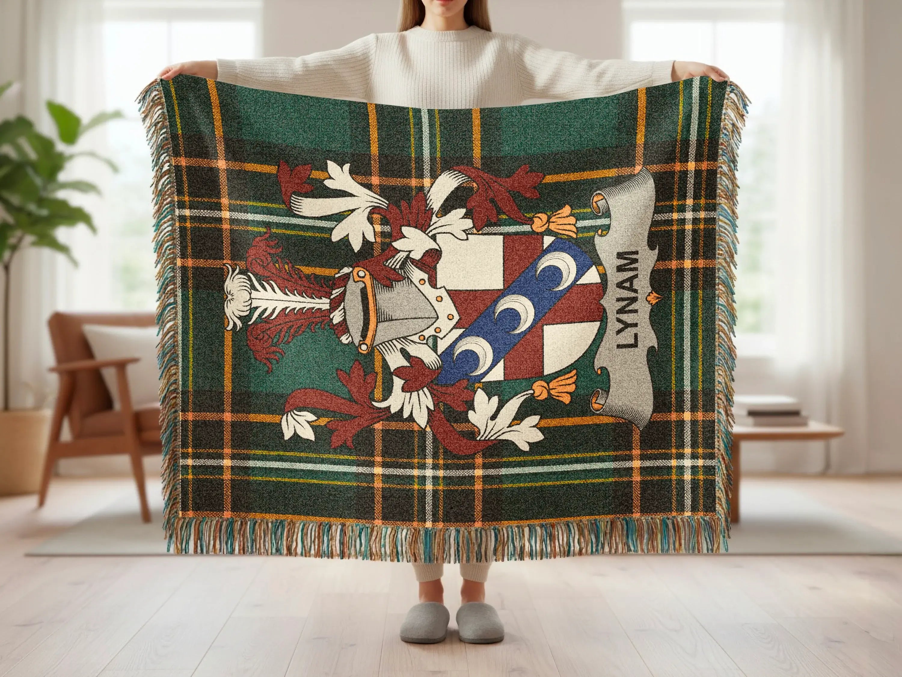 Green plaid throw blanket with a crest and the name "LYNAM".