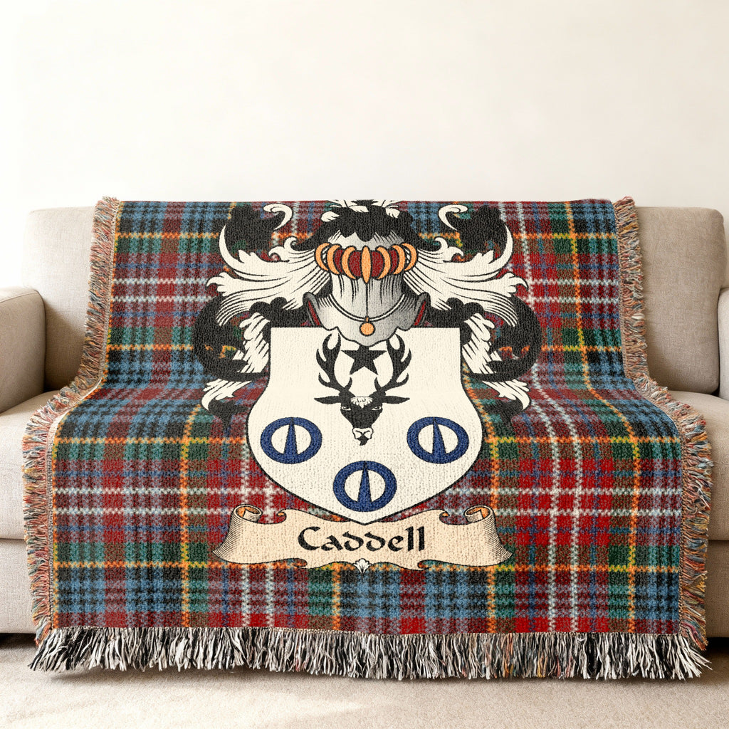 Caddell family crest emblem on a Caledonia tartan woven blanket