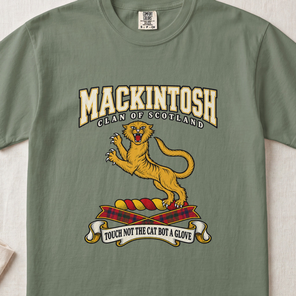 MacKintosh graphic T-shirt in Moss green, front flat lay showing varsity lettering and gold leaping wildcat with raised claws and open mouth.