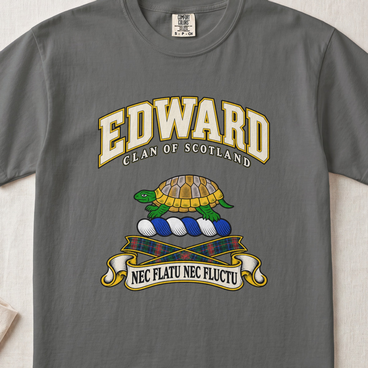 Edward Scottish clan T-shirt in Pepper, front view with a green and gold tortoise and motto design.
