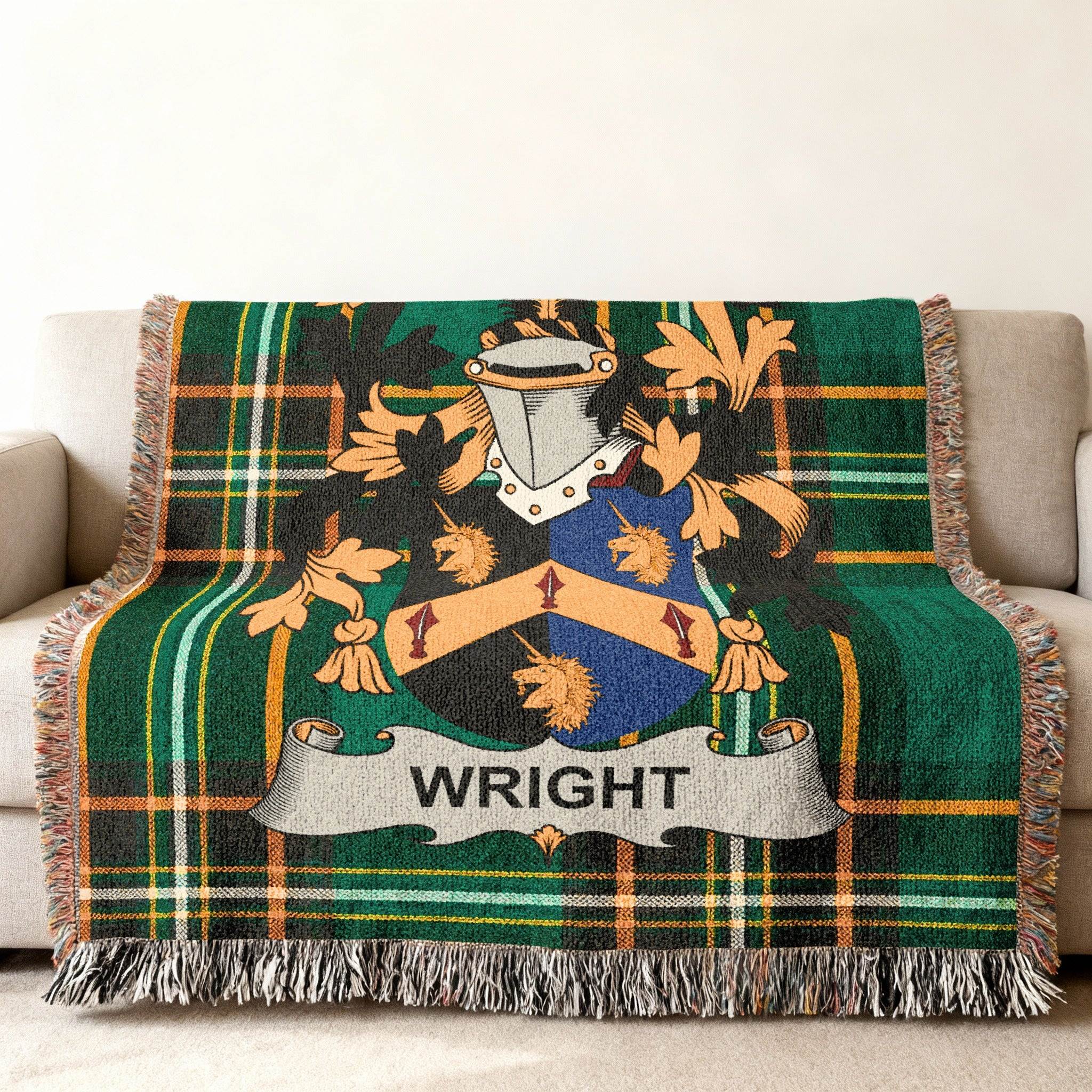 Wright family crest on a green tartan plaid throw blanket on a sofa.