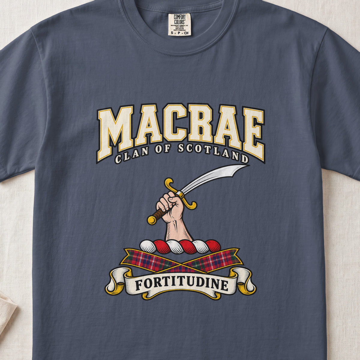 MacRae graphic T-shirt in Midnight blue, front flat lay showing varsity lettering and hand and forearm holding a curved silver sword with a gold hilt.